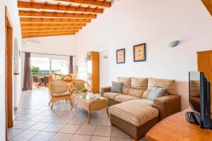a living room with a couch and a table at Villa Maru II by Villa Plus in Cala en Porter