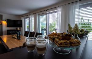 a table with a plate of food and glasses of water at Ferienwohnung Felicitas in Aichstetten