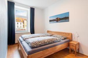 a bedroom with a bed and a window at Am Kanonenberg in Quedlinburg