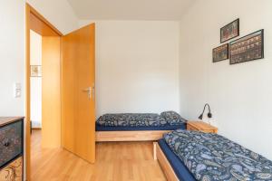 a small bedroom with a bed and a door at Am Kanonenberg in Quedlinburg +5 photos