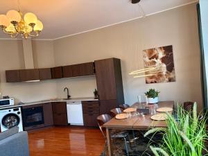 a kitchen and dining room with a table and chairs at Charming apartment Nygårdsparken in Bergen