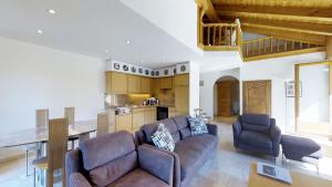 a living room with two couches and a kitchen at Corvatsch 3/47 in Silvaplana