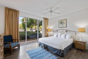 a bedroom with a bed and a large window at High Pointe Resort 131 in Inlet Beach +45 photos