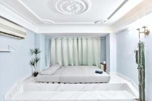 a bedroom with a bed in a room with blue walls at H2T Hotel Center BuiVien in Ho Chi Minh City