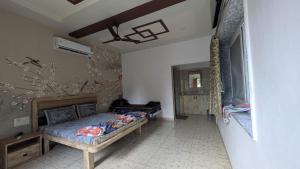 a bedroom with a bed in a room at The Gir Village Stay in Sasan Gir