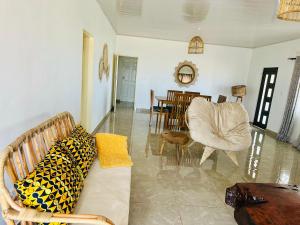 a living room with a couch and chairs and a table at Mulanje Vista House in Mulanje