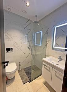 a bathroom with a shower and a sink and a toilet at Abdellah Tabrikt in Kenitra