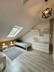 a attic bedroom with a bed and a skylight at M&M House in Okuninka