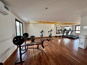 a gym with treadmills and exercise bikes in a room at Luxury Studio in Salta +17 photos