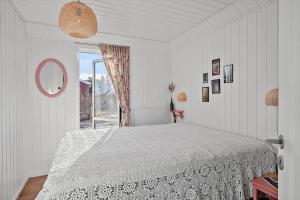 a white bedroom with a bed and a window at 0090-Romo-Lakolk-256 in Lakolk