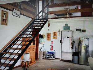 a spiral staircase in a room with a refrigerator at Mouck's Paradise in Tambe