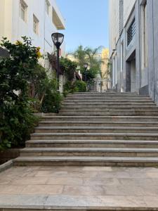 a set of stairs in a city with buildings at kenitra appartement premium in Kenitra +2 photos