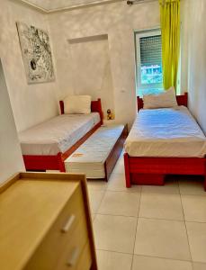 a bedroom with two beds and a window at kenitra appartement premium in Kenitra