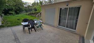 a patio with chairs and a table on a house at Chez Bio in Coulommiers