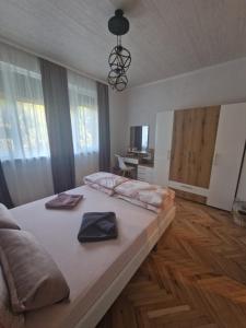 a bedroom with a large bed with two napkins on it at Z - apartment 2 in Tryavna