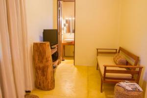a living room with a couch and a television at Casa Fufi in Jericoacoara