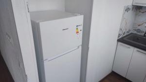 a white refrigerator in a kitchen with its door open at Studio Art in Sillamäe