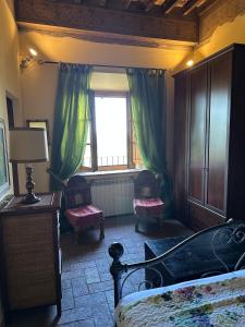 a bedroom with a bed and a window at La Casina di Pinutte in Campagnatico