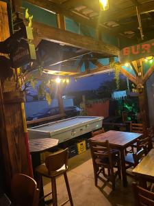 a bar with a pool table and chairs in a restaurant at Seven76Residence in Barra Velha +10 photos