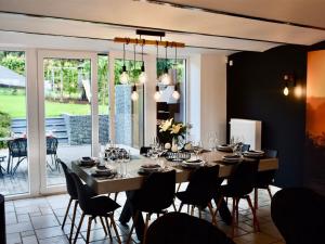 a dining room with a long table and chairs at Holiday Home in Manhay near Ski Area in Manhay