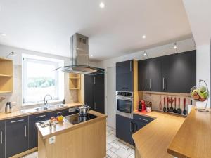 a kitchen with black cabinets and a counter top at Holiday Home in Manhay near Ski Area in Manhay