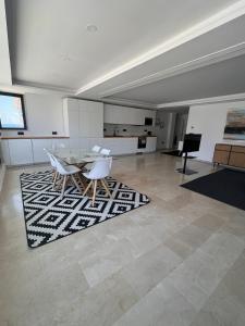 a dining room with a table and white chairs at Exclusive Apartment in Fuengirola in Fuengirola