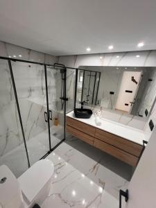 a bathroom with a shower and a toilet and a sink at Exclusive Apartment in Fuengirola in Fuengirola +6 photos