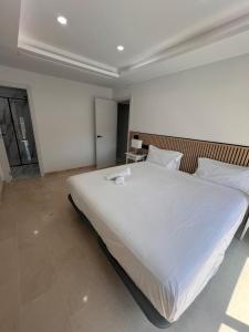 a bedroom with a large white bed in a room at Exclusive Apartment in Fuengirola in Fuengirola