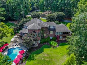 an aerial view of a house with a swimming pool at Bama Lakeside Retreat in Tuscaloosa