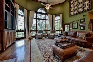 a living room with a couch and a tv at Bama Lakeside Retreat in Tuscaloosa