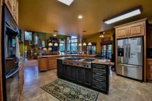 a large kitchen with wooden cabinets and stainless steel appliances at Bama Lakeside Retreat in Tuscaloosa