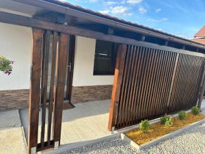 a wooden door on a house with some plants at Aqua Garden Junior Miercurea Ciuc in Miercurea-Ciuc