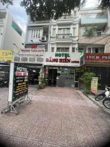 a hotel with signs in front of a building at hotel đặng hiền lương in Ho Chi Minh City