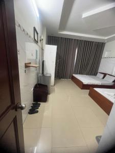 a room with two beds and a television in it at hotel đặng hiền lương in Ho Chi Minh City