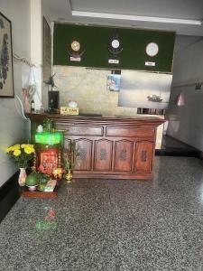 a room with a wooden counter with flowers on it at hotel đặng hiền lương in Ho Chi Minh City +5 photos