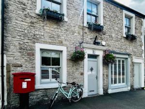 a bike parked in front of a brick building at The Green Room in Tideswell