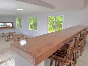 a large wooden table in a room with chairs at Forest 15 min from Manta Beach in Pacoche +29 photos