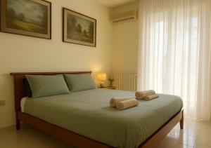 a bedroom with a bed with two towels on it at ATTICO A CORSICO - Navigli e San Siro a 15 minuti in Milan