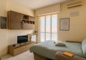 a bedroom with a bed and a flat screen tv at ATTICO A CORSICO - Navigli e San Siro a 15 minuti in Milan