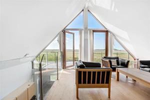 a room with chairs and a table and windows at 0344-Romo-Vestergade-331 in Sønderby
