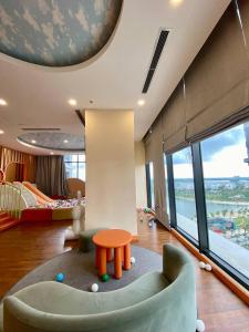 a living room with a couch and a table at 1BR Supper King View Vip Luxury in Long Bình