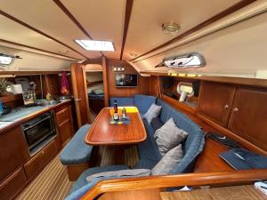 a dining room with a table and blue chairs at Baby Two Sailing Boat in Limanu