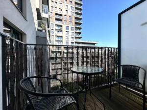 a balcony with two chairs and a table on a balcony at Walońska 19 Apart - SPA & Parking in Wrocław