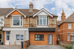 an old brick house with white windows at Parkstone Central by Grandeur Property in Parkstone