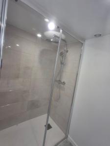 a shower with a glass door in a bathroom at Nantes Central & Calm in Nantes