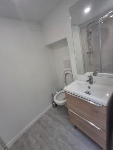 a white bathroom with a sink and a toilet at Nantes Central & Calm in Nantes
