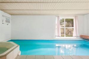 a bathroom with a swimming pool in the floor at 0203-Romo-Peder-Jespersensvej-4 in Tagholm