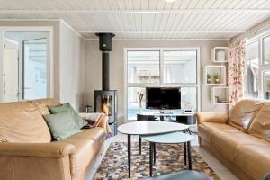 a living room with a couch and a fireplace at 0203-Romo-Peder-Jespersensvej-4 in Tagholm