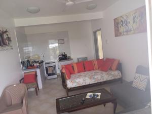 a living room with a couch and a table at Kijani unique home Malindi in Malindi