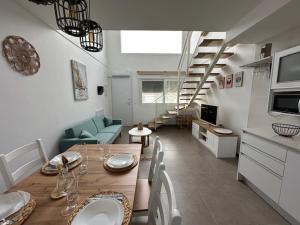 a dining room and living room with a table and chairs at Beach House Renata in Gran Alacant